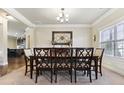 Traditional dining room with a large window and decorative chandelier with seating for eight at 2511 Day Break Way, Dacula, GA 30019