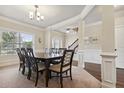Elegant dining room featuring crown molding, decorative trim and seating for eight guests at 2511 Day Break Way, Dacula, GA 30019