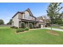 Charming two-story home with well-maintained landscaping, lush lawn, and a two-car garage at 2511 Day Break Way, Dacula, GA 30019