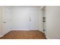 Condo entryway featuring hardwood floors and white trim, with a view of the kitchen at 2637 Peachtree Ne Rd # 407, Atlanta, GA 30305