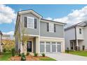 Beautiful home with gray siding, white trim, a black front door, and a spacious three-car gray garage at 2762 Aralynn Way, College Park, GA 30337