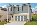Charming home with well-manicured lawn and a convenient three-car gray garage, offering both style and functionality at 2762 Aralynn Way, College Park, GA 30337