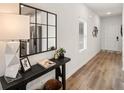 Bright entryway featuring hardwood floors, stylish console table, modern mirror, and natural light at 6418 Rosetta Dr # 49, South Fulton, GA 30331
