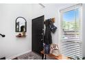 Inviting entryway with a black door, stylish mirror, and coat rack for organized convenience at 105 Park Ridge Cir, Marietta, GA 30068