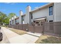 View of the townhome's side, with a sidewalk, fence, and lush trees offering privacy and charm at 105 Park Ridge Cir, Marietta, GA 30068