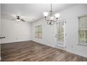 Dining area with hardwood floors, abundant natural light, and a modern chandelier at 3095 Bonnes Dr, Lithonia, GA 30038
