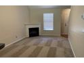 Inviting living room featuring a fireplace and large window for natural light at 3108 Broadleaf Trl, Fairburn, GA 30213