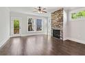 Open living room with hardwood floors and a stone fireplace provides a cozy space at 682 Shelton Sw Ave, Atlanta, GA 30310