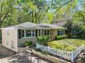 Charming single-story home with fresh landscaping and a white picket fence in a serene, tree-lined neighborhood at 2585 Acorn Ne Ave, Atlanta, GA 30305