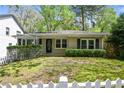 Charming single-story home with fresh landscaping and a manicured lawn in a serene, tree-lined neighborhood at 2585 Acorn Ne Ave, Atlanta, GA 30305