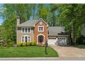 Traditional two-story house with a well-manicured lawn, brick facade, and an attached two-car garage at 3362 Timber Rdg, Powder Springs, GA 30127