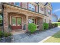 Inviting brick-arched front porch with double doors and meticulous landscaping for a warm, welcoming entrance at 6150 Birchfield Trl, Cumming, GA 30041