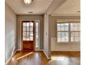 Bright foyer with hardwood floors, decorative lighting, and a view to the living space at 90 Ashford Dr, Oxford, GA 30054