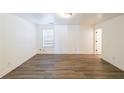 A well-lit bedroom featuring modern gray floors, white walls, and ample space for furniture arrangement at 1294 Park Pass Way, Suwanee, GA 30024