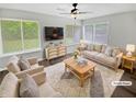 Bright living room with large windows, neutral decor, plush seating, and stylish furnishings at 245 Adena W Ln, Atlanta, GA 30349