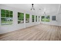 Bright and airy sunroom with large windows, wood plank flooring, and ample natural light at 3452 Ridgecrest Dr, Powder Springs, GA 30127