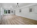 Sunroom featuring multiple windows, modern lighting, and wood plank flooring at 3452 Ridgecrest Dr, Powder Springs, GA 30127