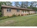 Ranch-style home with brick and grass lawn at 6436 Alpine Rd, Rex, GA 30273