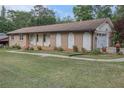 Cozy brick home boasts a well-kept lawn and an attached two-car garage at 6436 Alpine Rd, Rex, GA 30273