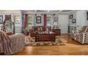 Inviting living room with hardwood floors, stylish furniture, and coffered ceilings at 6436 Alpine Rd, Rex, GA 30273