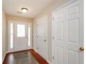Bright foyer with tile flooring, fresh paint, multiple closets, and a glass front door at 854 Nichols Landing Ln, Dacula, GA 30019