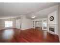 Spacious living room featuring hardwood floors, fireplace, and large windows for natural light at 854 Nichols Landing Ln, Dacula, GA 30019