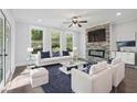 Bright living room with stone fireplace, modern furniture, hardwood floors, and lots of natural light at 1002 Coleman Sw St, Atlanta, GA 30310