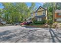 Two-story traditional home featuring lush landscaping and a private driveway with mature trees at 2008 Falcon Glen Ct, Alpharetta, GA 30022