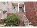 Brick entryway to home featuring a staircase leading to the front door at 320 Town Center Ave # U206B, Suwanee, GA 30024