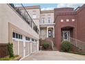 Multi-level house featuring a brick entry and an attached two-car garage at 320 Town Center Ave # U206B, Suwanee, GA 30024