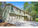 Charming home with attached garage and covered porch, surrounded by lush greenery at 1855 Mountain Trce, Canton, GA 30114