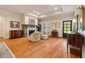 Elegant living room with hardwood floors, fireplace, recessed lighting, and stylish furnishings and decor at 2550 Ballantrae Cir, Cumming, GA 30041