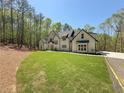 Beautiful two-story home with a sprawling front lawn, lush landscaping and architectural design at 5567 Tyree Rd, Winston, GA 30187