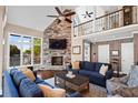 Cozy living room featuring a stone fireplace, soaring ceilings, and comfortable seating at 6360 Spinnaker Ln, Alpharetta, GA 30005