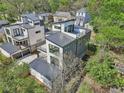 Aerial view showcasing the modern home's unique architecture, metal roof, and surrounding neighborhood at 1140 Hubbard Sw St, Atlanta, GA 30310