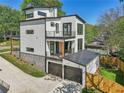 Modern home featuring a two-car garage, a balcony, and a well-manicured lawn at 1140 Hubbard Sw St, Atlanta, GA 30310