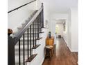Elegant entryway with hardwood floors and a staircase with wrought iron spindles at 1931 Mceachern Manor Sw Dr, Marietta, GA 30064