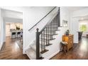Elegant entryway with hardwood floors and a staircase with wrought iron spindles at 1931 Mceachern Manor Sw Dr, Marietta, GA 30064
