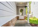 Inviting front porch featuring a decorative wreath, stone accents, and tidy landscaping at 206 Cole Ct, Canton, GA 30114