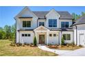 Charming two-story home boasts a welcoming entrance and beautifully landscaped front yard at 4059 Yellow Creek Trl, Cumming, GA 30028