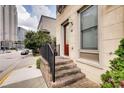 Home entrance featuring brick steps, black railing, and a view of the street at 384 16Th Nw St # 1, Atlanta, GA 30363