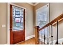 Entryway view with a wood door, staircase, and natural light streaming through the window at 384 16Th Nw St # 1, Atlanta, GA 30363
