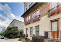 Townhome exterior showcasing brick and stone architecture, balconies, and lush greenery at 384 16Th Nw St # 1, Atlanta, GA 30363
