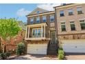 Charming two-story brick townhome featuring a private entry with access steps and an attached two-car garage at 823 Canterbury Overlook, Atlanta, GA 30324