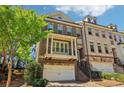 Charming brick townhouse with a balcony, two-car garage, and landscaped front at 823 Canterbury Overlook, Atlanta, GA 30324