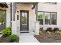 Inviting front entrance with stylish door, manicured landscaping, and brick accents at 4068 Allegretto Se Cir # 10, Atlanta, GA 30339
