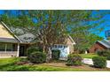 Charming home showcasing the garage, a well-maintained lawn and a basketball hoop at 925 Wynn Rd, Mcdonough, GA 30252