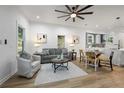 Inviting living room with hardwood floors, large windows, and modern decor leading to the kitchen at 1430 Fairbanks Sw St, Atlanta, GA 30310