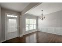 Elegant dining room with hardwood floors, chandelier, and large windows at 2656 Staunton Ln, Duluth, GA 30096