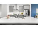 Modern kitchen with stainless steel appliances, gray cabinets, and white countertops at 332 Gibson Se St, Atlanta, GA 30316